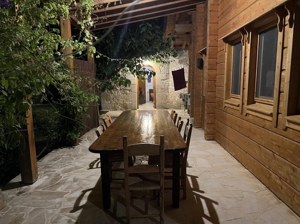 Pergola dining with stone walls and amphorae