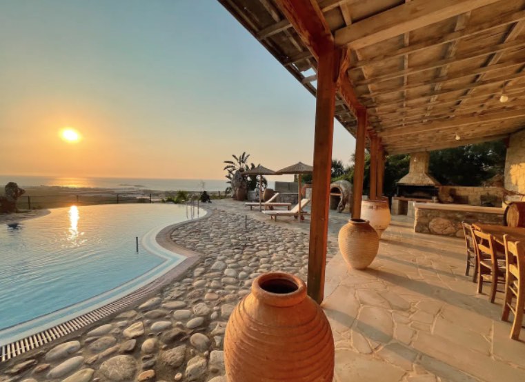 Pool at golden sunset with amphorae and pergola