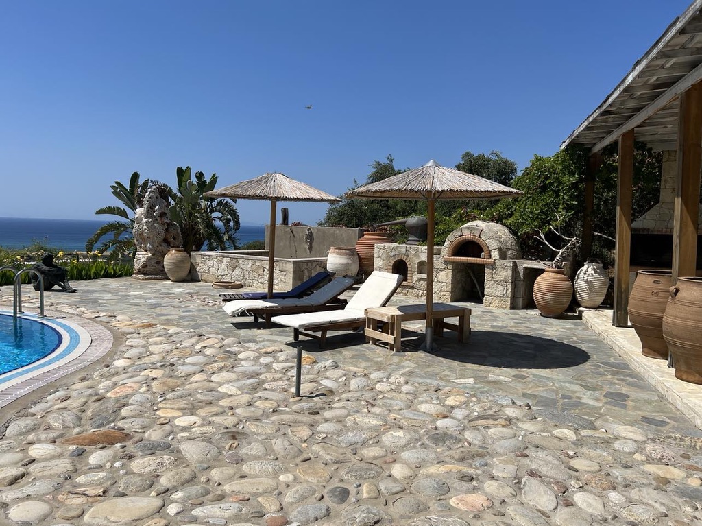 Cobblestone pool terrace with amphorae and stone oven